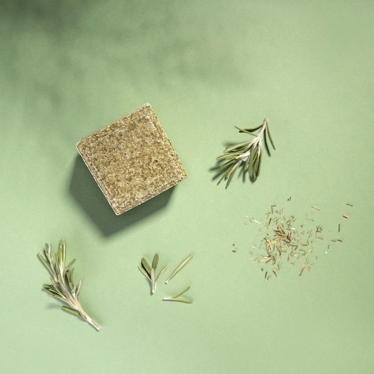 yogh hair fortifying vegan shampoo bar with horsetail and rosemary on green background with its ingredients