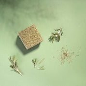 yogh hair fortifying vegan shampoo bar with horsetail and rosemary on green background with its ingredients