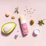 solid facial moisturiser with main ingredients on pink background