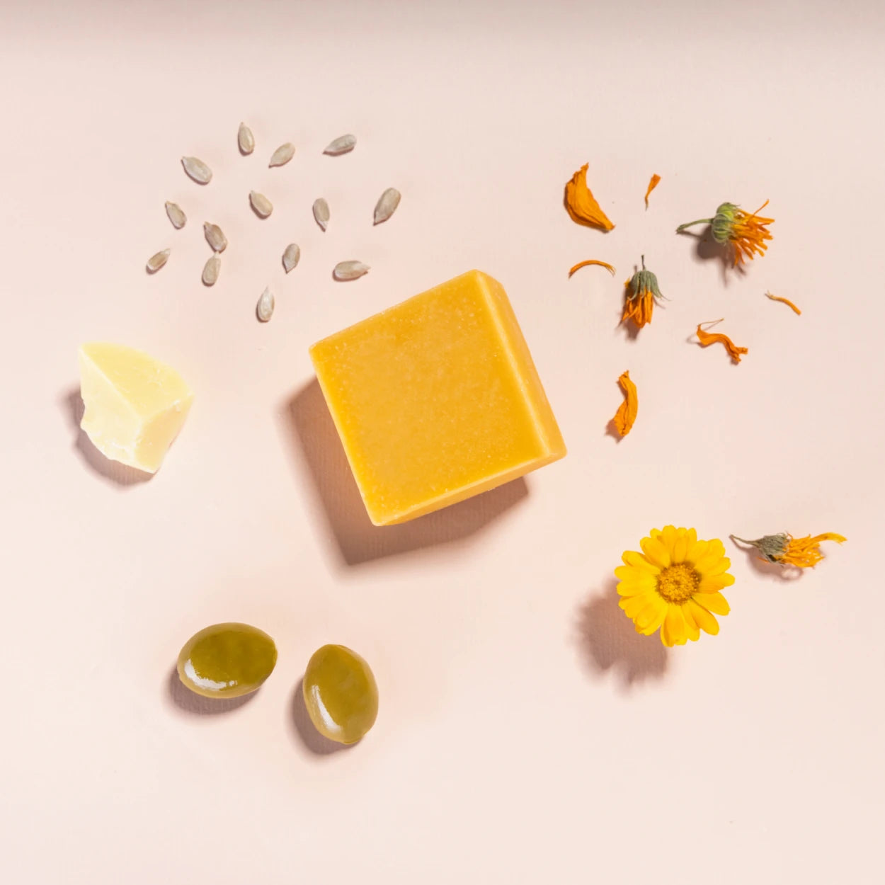 make up cleansing bar product on pink background with main ingredients