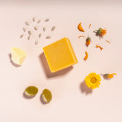 make up cleansing bar product on pink background with main ingredients