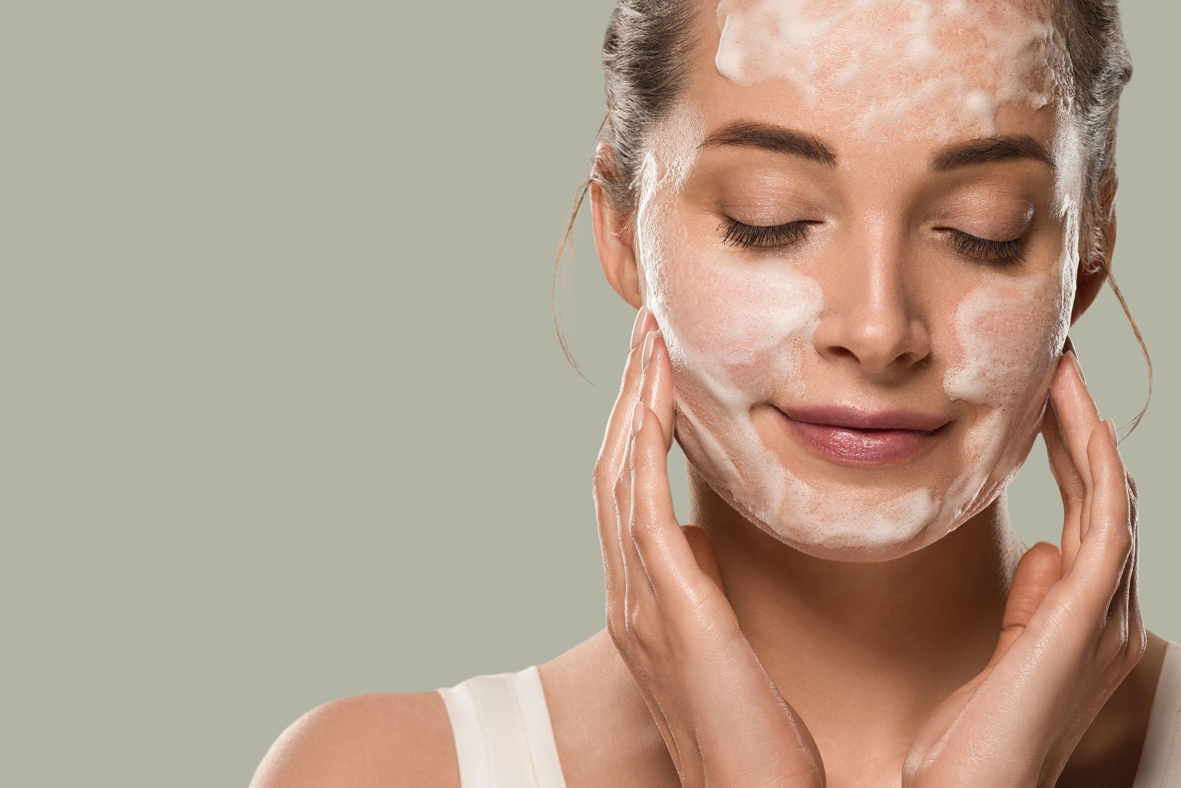 woman applying foamy face mask