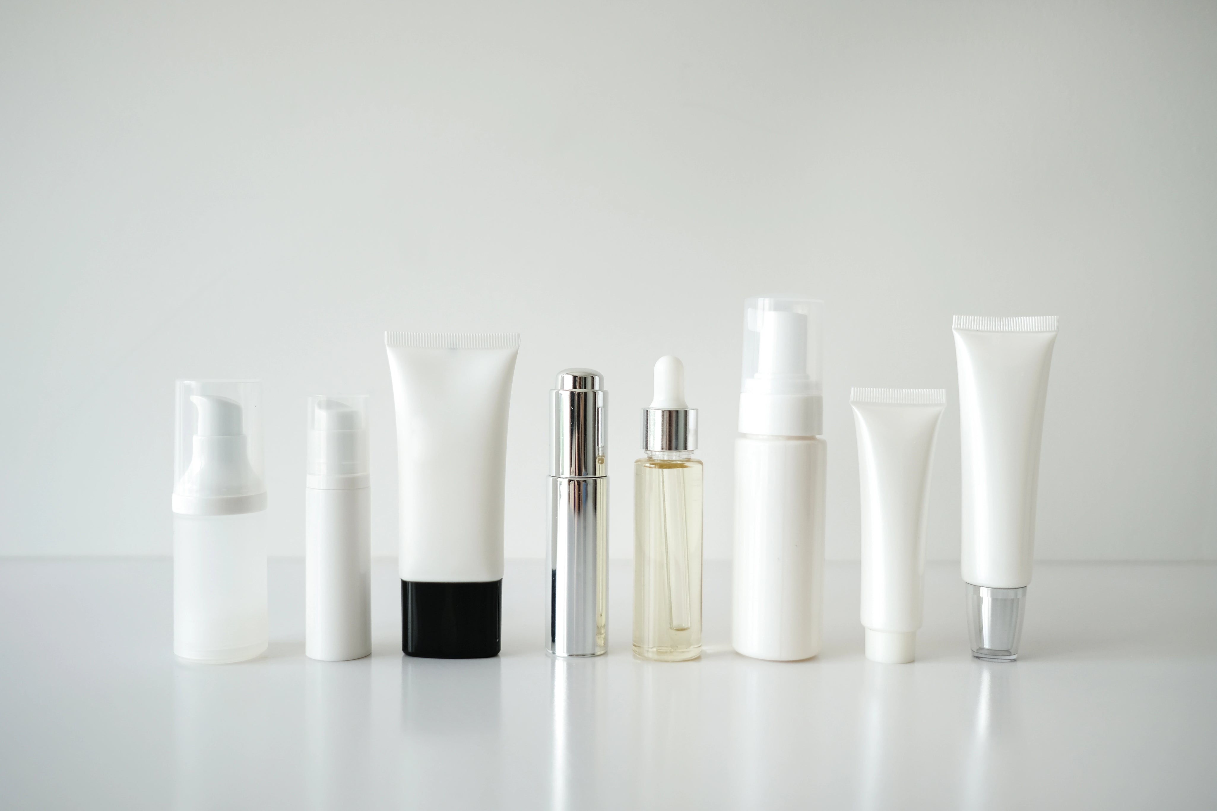 cosmetic products in plastic packaging on white background