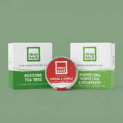 products of yoghhair bundle for strong hair arranged next to eachohter on a green background. conditoner on the left, hair mask in the middle and shampoo on the right