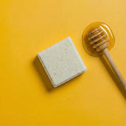 yoghhair honey shampoo next to its main ingredient honey