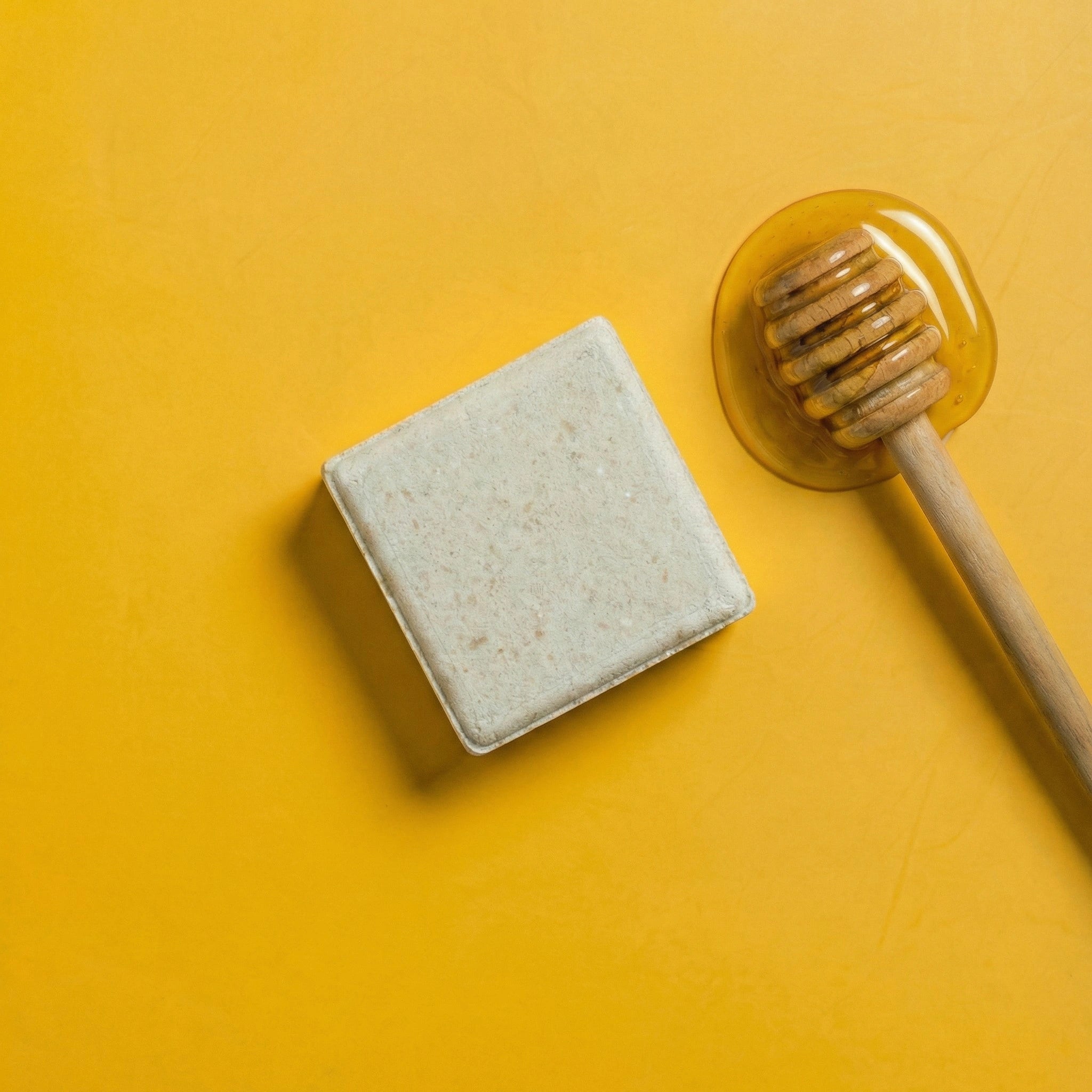 yoghhair honey shampoo next to its main ingredient honey
